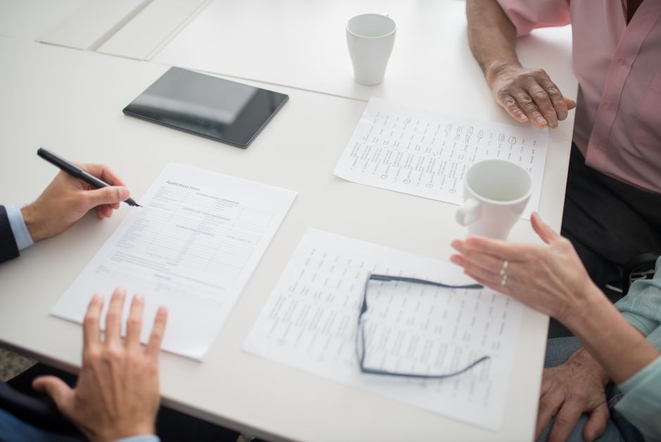 Person reviewing paperwork to understand how does COBRA health insurance work after leaving a job